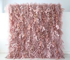 a pink wall hanging on the side of a white wall