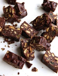 pieces of chocolate and nuts on a white plate