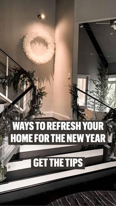 the stairs are decorated with greenery and wreaths on each handrail in this modern home