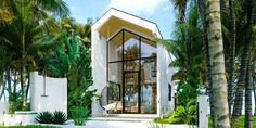 a white house surrounded by palm trees and greenery