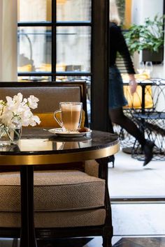 two chairs and a table with flowers on it