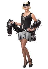 a woman in a black and silver flap dancer costume posing for the camera with her hands on her hips