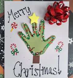 a handprinted christmas card with a red bow on it and a green hand