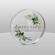 a clear glass plaque with greenery on it