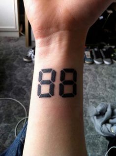 a wrist tattoo with the time displayed on it