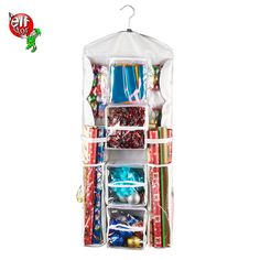 an open christmas gift bag filled with lots of holiday decorations and wrapping paper on a white background