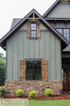 a house with stone and wood trim on the front