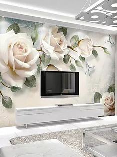 the living room is decorated with white roses and green leaves on it's wall