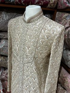 This beige white royal sherwani is brought into limelight with fine jaal embroidered coat enhanced with resham, pearl ,stone & cut dana work. The coat is styled with matching churidar pants. Size:40,42,44 Occasion: Wedding Ceremony or Reception WASH CARE INSTRUCTIONS - Please Dry clean only when it is applicable. Slight color variation is possible due to digital photography. Ready to Ship! Off White Traditional Wear With Dabka For Designer Occasions, Off White Bandhgala With Naqshi For Festive Occasions, Off White Naqshi Bandhgala For Festive Occasions, Long Sleeve Kurta With Naqshi For Reception, Cream Churidar For Reception In Transitional Season, Cream Churidar For Reception, Transitional Cream Churidar For Reception, Festive Off White Bandhgala With Naqshi, Off White Naqshi Sherwani For Diwali