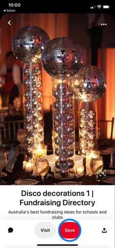 a table topped with lots of disco balls and candles next to a mirror ball centerpiece