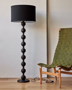 a chair next to a lamp on a hard wood floor