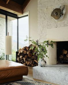 a living room filled with furniture and a fire place in front of a stone fireplace