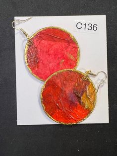 Add some unique flair to your jewelry collection with these beautiful handmade earrings by Russell and Joyce. These earrings are crafted from paper and hand-painted with a  Red & Pink  design, making each pair completely one-of-a-kind. The dangle/drop style adds a touch of elegance to any outfit, and the   multi-colored color combination is perfect for adding a pop of color to your look. These earrings are lightweight and comfortable to wear all day long. With no stones, they are perfect for any occasion. See photo with front and back. Buy 2 pair and shipping is free Handmade Artisan Red Earrings, Artsy Red Earrings As A Gift, Artistic Handmade Pink Earrings, Red Hand Painted Round Earrings, Artistic Red Round Earrings, Hand Painted Pink Round Earrings, Artistic Red Earrings With Ear Wire, Handmade Pink Circular Earrings, Handmade Pink Circle Earrings