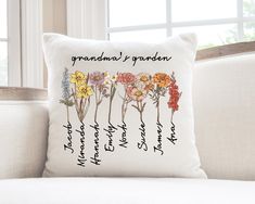 a white pillow with flowers on it and the words grandma's garden