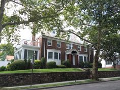 a large brick house sitting on the side of a road