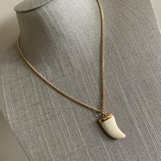 Vintage faux horn or tooth pendant necklace in gold tone metal  A faux tooth or horn pendant necklace. Unisex style. On a gold tone chain with spring ring clasp. In good used condition.  Size  Pendant 1 inches  Chain 16 inches Horn Pendant Necklace, Horn Pendant, Gold Tone Metal, Spring Rings, Unisex Fashion, Chains Necklace, Gold Tones, Jewelry Necklaces, Pendant Necklace