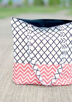 a pink and white bag sitting on top of a wooden table