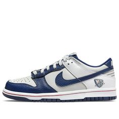 Nike's Dunk Low GS is a must-have sneaker for any big kid. This shoe celebrates the NBA's 75th anniversary with a Nets-inspired color scheme, complete with tumbled leather overlays in white and Blue Void. The lateral heel graphic nods to the franchise's current home in Brooklyn, while unique branding elements include a tongue tag with the 75th anniversary logo and a diamond-etched lace dubrae. The red stitching on the white midsole adds a pop of contrast, while the navy rubber outsole provides support and durability. (SNKR/Retro/Skate/Casual/Low Top/Brooklyn Nets) Collegiate Basketball Shoes With Boost Midsole For Streetwear, Collegiate High-top Basketball Shoes With Boost Midsole, Collegiate Low-top Basketball Sneakers, Throwback Round Toe Basketball Sneakers, Nike Low-top Throwback Basketball Shoes, Nike Throwback Low-top Basketball Shoes, Throwback Basketball Shoes With Branded Insole, Throwback Round Toe Basketball Shoes, Throwback Basketball Shoes With Cushioned Footbed