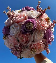 a bridal bouquet in the shape of a bride's bouquet with pink and purple flowers