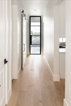 A hallway with light, modern white oak floors. A glass door at the end of the hallway looks out onto a lake. Wide Plank White Oak Floors, White Oak Hardwood Floors, Oak Hardwood Flooring, White Oak Floors, Wide Plank Flooring, Wide Plank, Wood Flooring, House Flooring, Home Reno