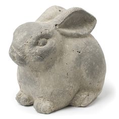 a white rabbit statue sitting on top of a table