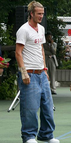 a man standing on top of a tennis court holding a racquet in his hand