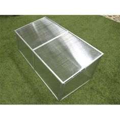 a large metal box sitting on top of green grass