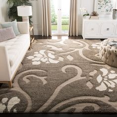 a living room filled with furniture and a large rug