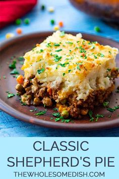 a close up of a plate of shepherd's pie on a blue table cloth