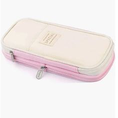 a small pink and white case sitting on top of a table