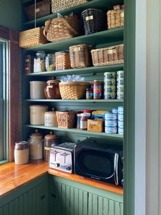 a green pantry filled with lots of food