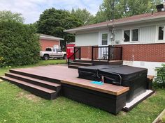 a house with a deck and hot tub in the yard