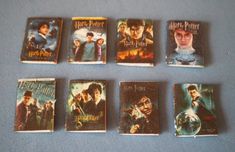 a collection of harry potter books are arranged on a blue tablecloth with white writing