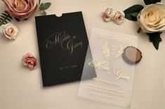 the wedding stationery is laid out next to flowers and cards with gold foil on them