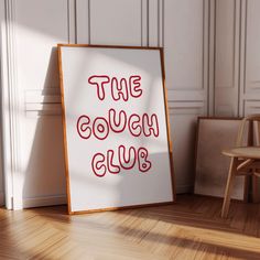 a sign that says the couch club on it in front of a chair and door