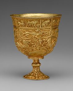 an ornately decorated gold goblet, possibly in the middle ages or early 20th century