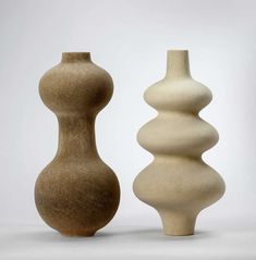 two vases sitting next to each other in front of a white background with the caption'still life store '