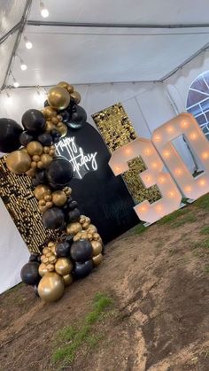 a tent with balloons and letters on it