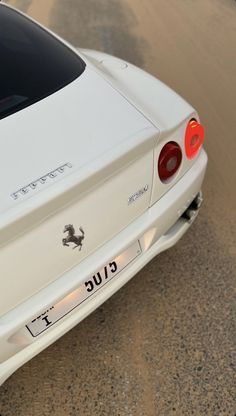 the rear end of a white sports car