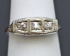 Antique Art Nouveau / Edwardian 18K White Gold  3 Stone Diamond Milgrain Ring  Natural Old Mine Cut Diamonds: approx. 1/3cttw  Head of Ring measures approx 6.5mm tall Weight: 2.9 Grams Size: 7 1/4 There is detailing throughout this entire ring!  This is a pre-owned ring in excellent condition (CAT 24-92301) Milgrain Ring, Old Mine Cut Diamond, Ring Size 7, Antique Art, Wedding Rings Engagement, Wedding Engagement, Halloween Shopping, Art Nouveau, Diamond Cuts