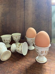 an egg is sitting in a cup next to other eggs