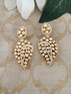 RESTOCKED  Material        : Silver Gemstone: Moissanite,  Stone colour:  Uncut Polki Primary colour: Gold Closure        : Screw back  Length: 5.5 cms  Width : 2.5 cms Intricate, hand crafted, Pure Silver Polki Earrings, studded with high quality Moissanite Polki ,made in 92.5 real silver with 22ct gold plating.  Product comes with 92.5 silver hallmark. All our pieces are in stock and will be dispatched with in 24 to 48 hours of order. Orders received  during the weekend will be dispatched on M Elegant Diamond Bridal Earrings With Stone Work, White Bridal Earrings With Stone Work For Formal Occasions, White Hand Set Teardrop Diamond Earrings, White Teardrop Hand Set Diamond Earrings, Elegant Stone Setting Earrings For Wedding, Elegant Stone-set Earrings For Wedding, Festive White Cubic Zirconia Earrings, Elegant Wedding Earrings With Stone Setting, Festive Wedding Earrings With Stone Setting