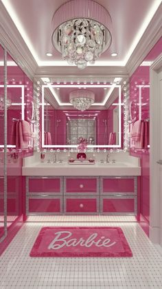 a pink bathroom with chandelier, mirror and rugs on the floor in front of it