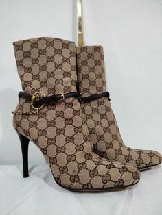 This 100% authentic Gucci GG monogram boot( 38 and half)5.5 is a must have! It's absolutely gorgeous and stylish. It fits every occasion. It's almost new! You can wear it  occasionally or casually. It's unique design commands an epitome of class and style. It's medium heeled with zips on its sides showcasing an elaborate chain design added to a finished leather cowboy rope! Designer High Ankle Winter Boots, Designer High-top Winter Boots, Gucci Aesthetic, Monogram Boots, House Additions, Gucci Boots, Girl Boots, Diy Clothes And Shoes, Outfit Inspired