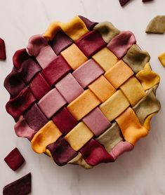 a colorful pie sitting on top of a white counter