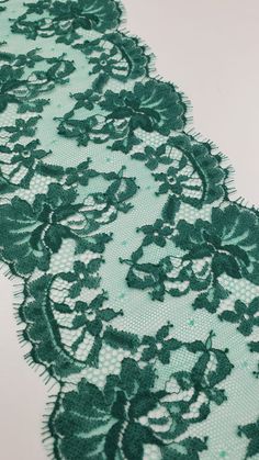 green lace with flowers and leaves on it