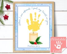 a christmas card with a candle and handprint on it