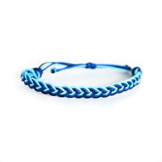 a blue braid bracelet on a white background