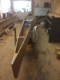 a canoe is sitting in the middle of a workshop