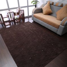 a living room area with a couch, chair and coffee table in front of a large window